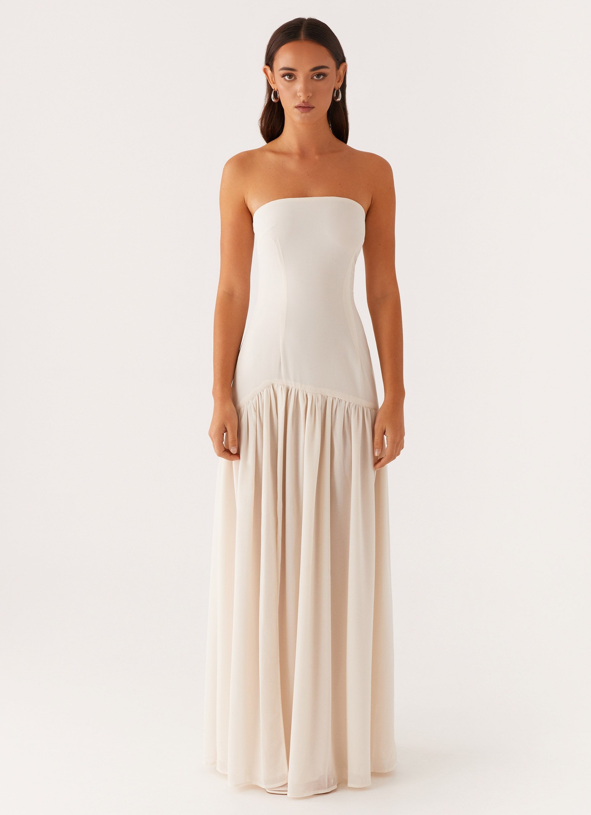eden strapless maxi dress Black / XS length maxi skirt creates an elongated streamlined profile for occasion wear Minimal seam detailing keeps the focus on clean lines and balanced proportions Concealed back fastening maintains a secure fit and uninterrupted finish The fit is close through the bodice with a softly flowing shape through the skirt for comfortable movement Ivory Strapless Dress Eden Strapless