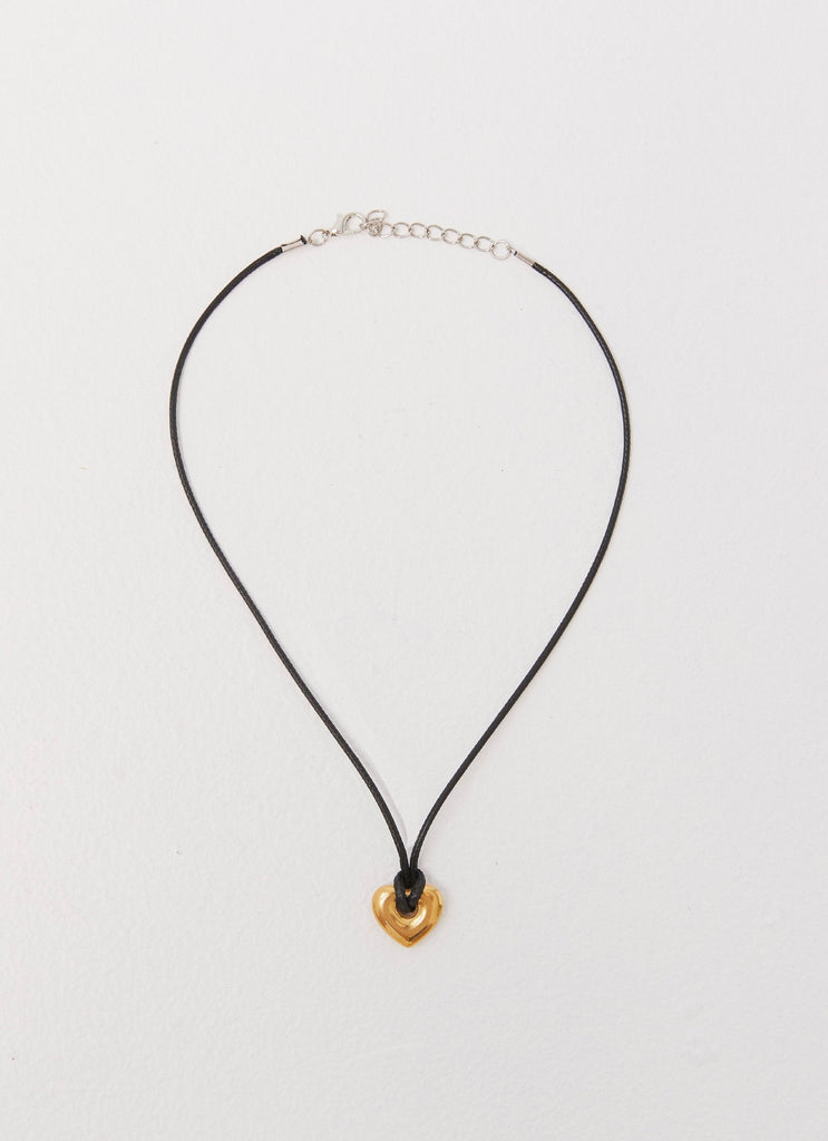 Womens Laney Heart Rope Necklace in the colour Gold in front of a light grey background