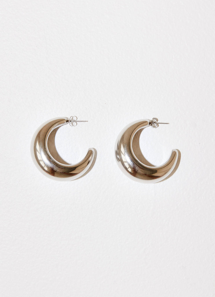 Womens Bon Voyage Hoop Earrings in the colour Silver in front of a light grey background