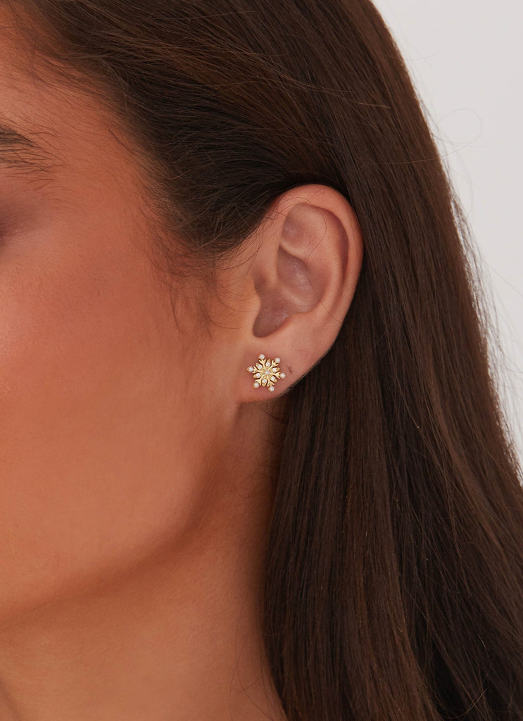 Womens Crystal Snowflake Earring in the colour Gold in front of a light grey background