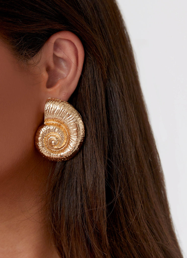 Womens Beachcomber Earrings in the colour Gold in front of a light grey background