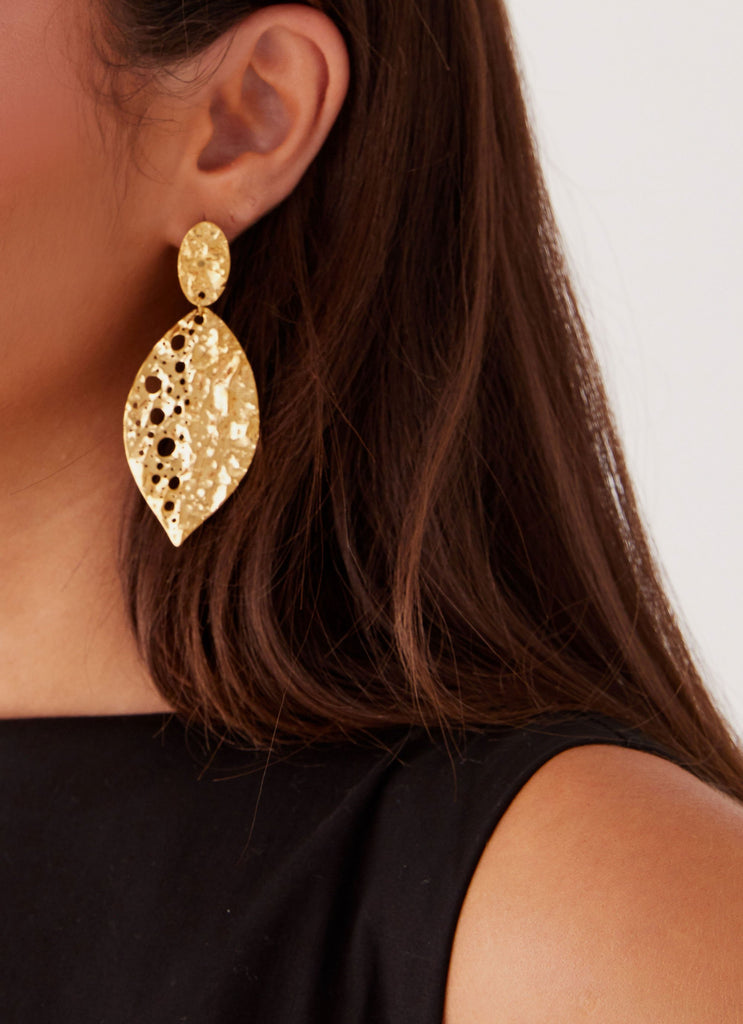 Womens Palm Earrings in the colour Gold in front of a light grey background