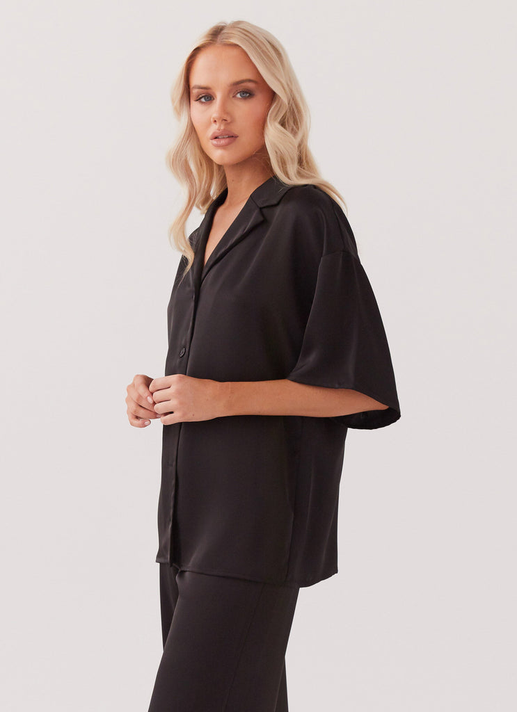 Womens Palm Cove Satin Shirt in the colour Black in front of a light grey background