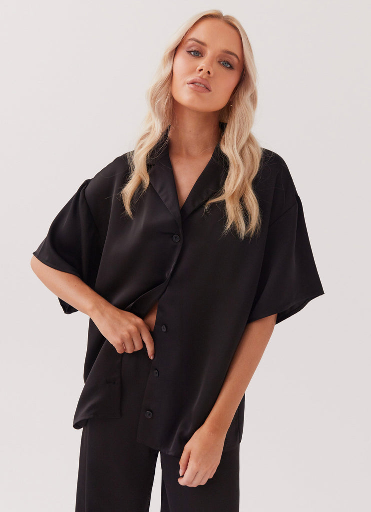 Womens Palm Cove Satin Shirt in the colour Black in front of a light grey background