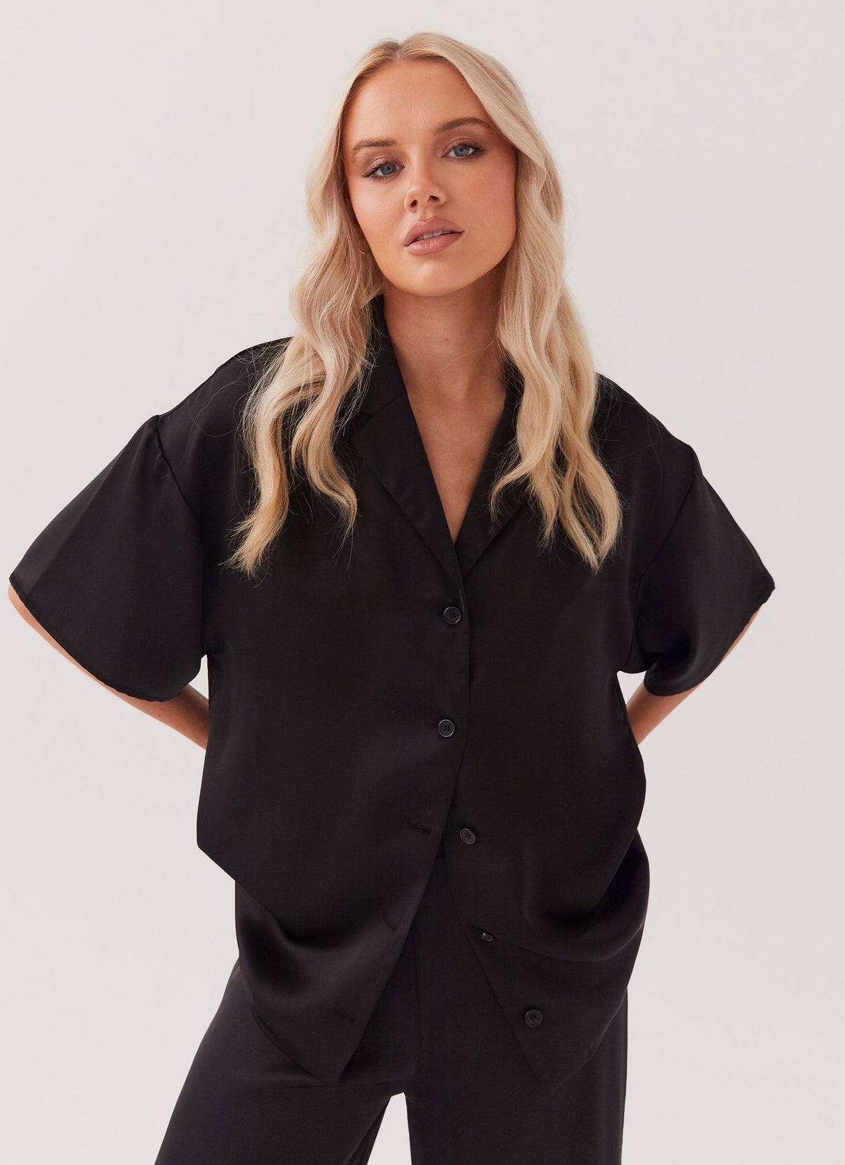 Womens Palm Cove Satin Shirt in the colour Black in front of a light grey background