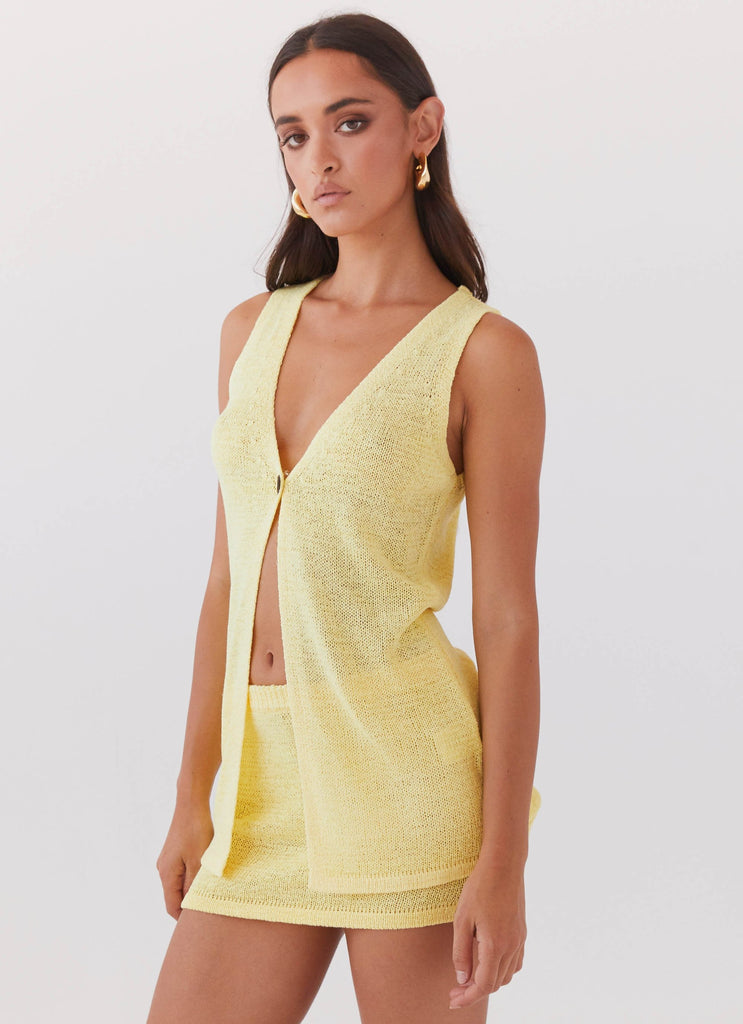 Womens Capri Glow Knit Mini Skirt in the colour Canary in front of a light grey background