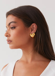 Womens Alexa Heart Earrings in the colour Gold in front of a light grey background