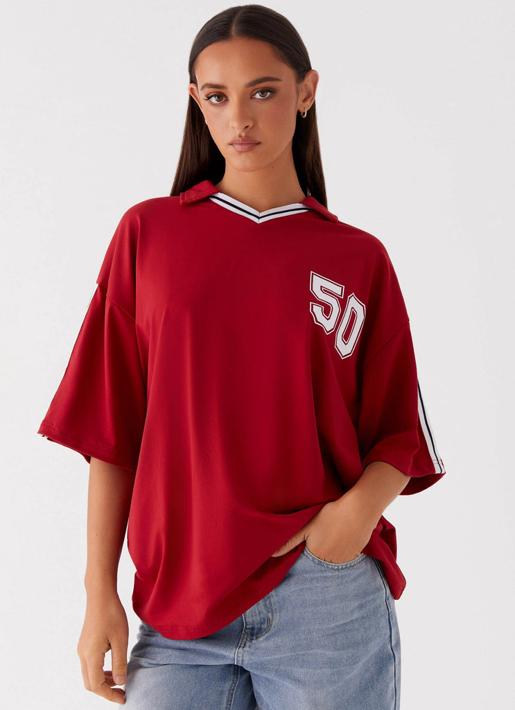 Womens Jayde Jersey Top in the colour Maroon in front of a light grey background