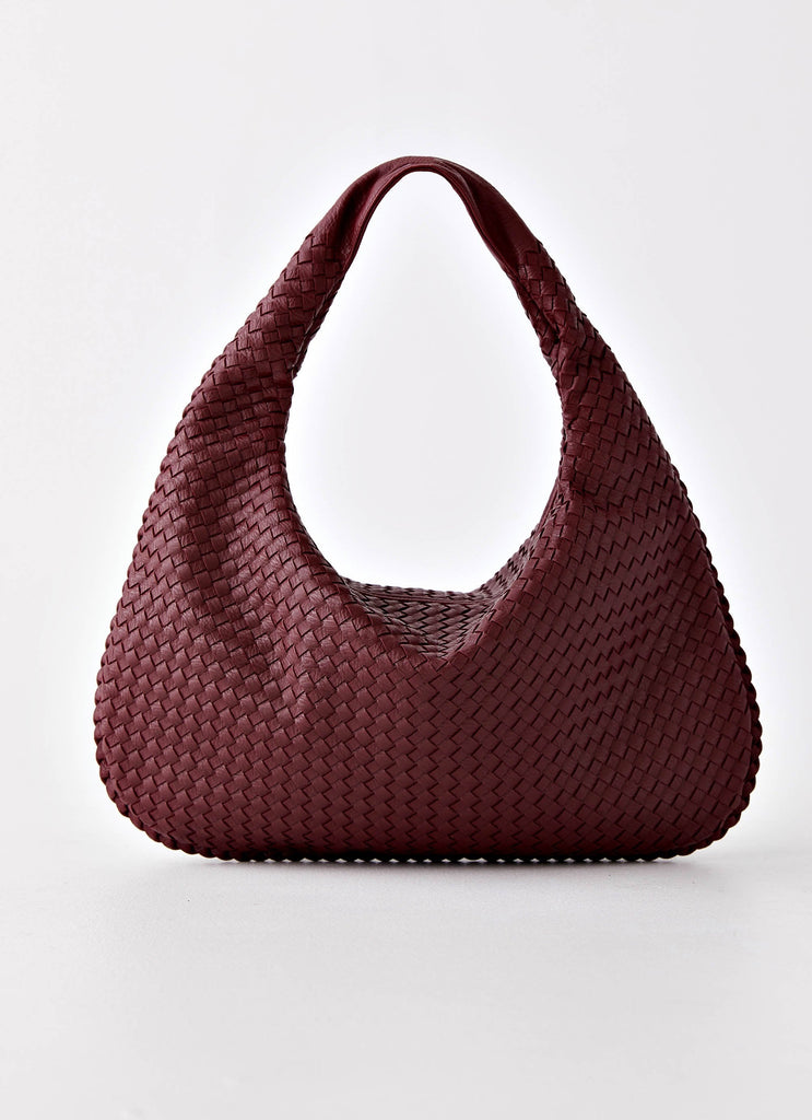 Womens Oriona Woven Handbag in the colour Dark Red in front of a light grey background