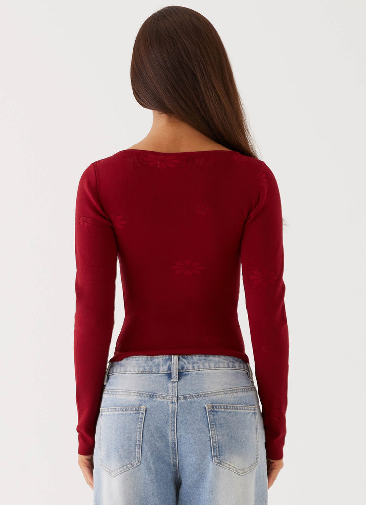 Womens Dandelion Long Sleeve Knit Top in the colour Red in front of a light grey background