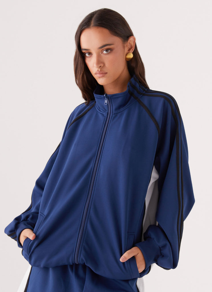 Womens Feel The Rush Track Jacket in the colour Vintage Blue in front of a light grey background