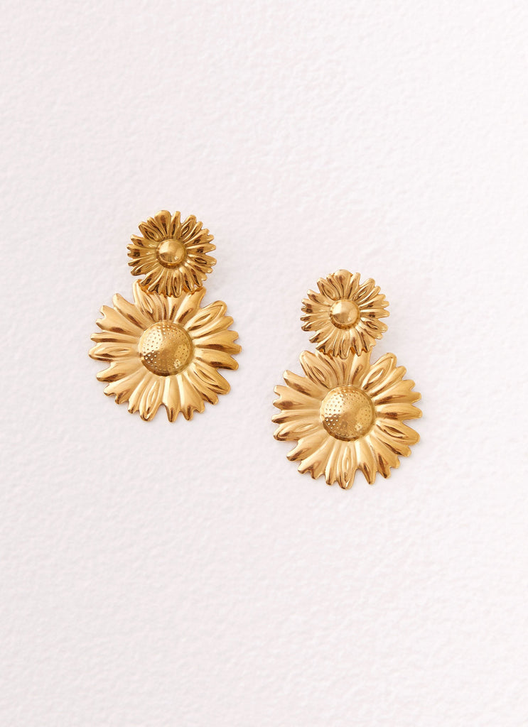 Womens Daisy Love Earrings in the colour Gold in front of a light grey background