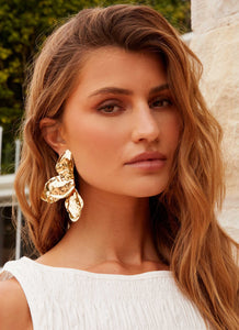 Womens Stonelet Statement Earrings in the colour Gold in front of a light grey background