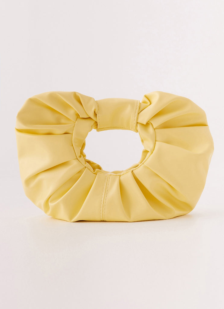 Womens Atavista Scrunchie Bag in the colour Yellow in front of a light grey background