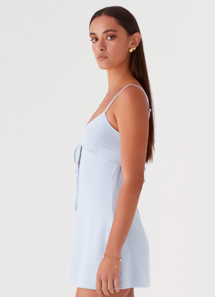 Womens Flora Linen Mini Dress in the colour Baby Blue in front of a light grey background