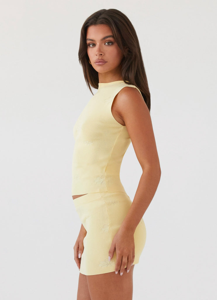 Womens Holly Knit Mini Skirt in the colour Lemon in front of a light grey background