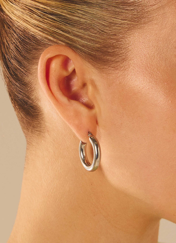 Womens Fade Away Hoop Earrings in the colour Silver in front of a light grey background