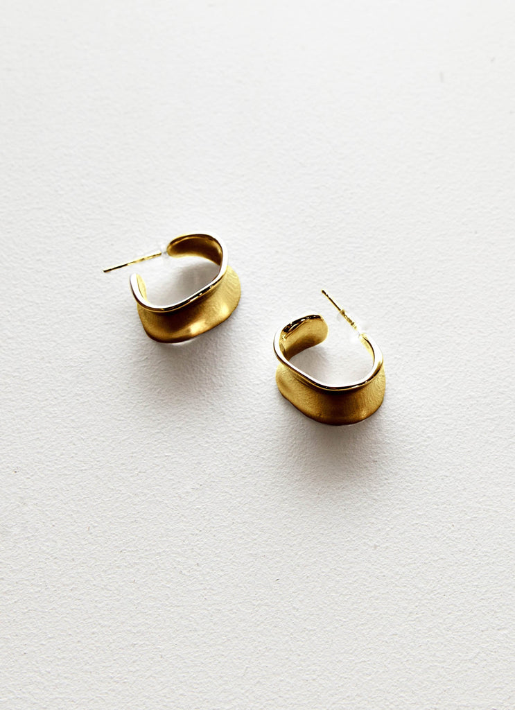 Womens More Than Words Hoop Earrings in the colour Gold in front of a light grey background