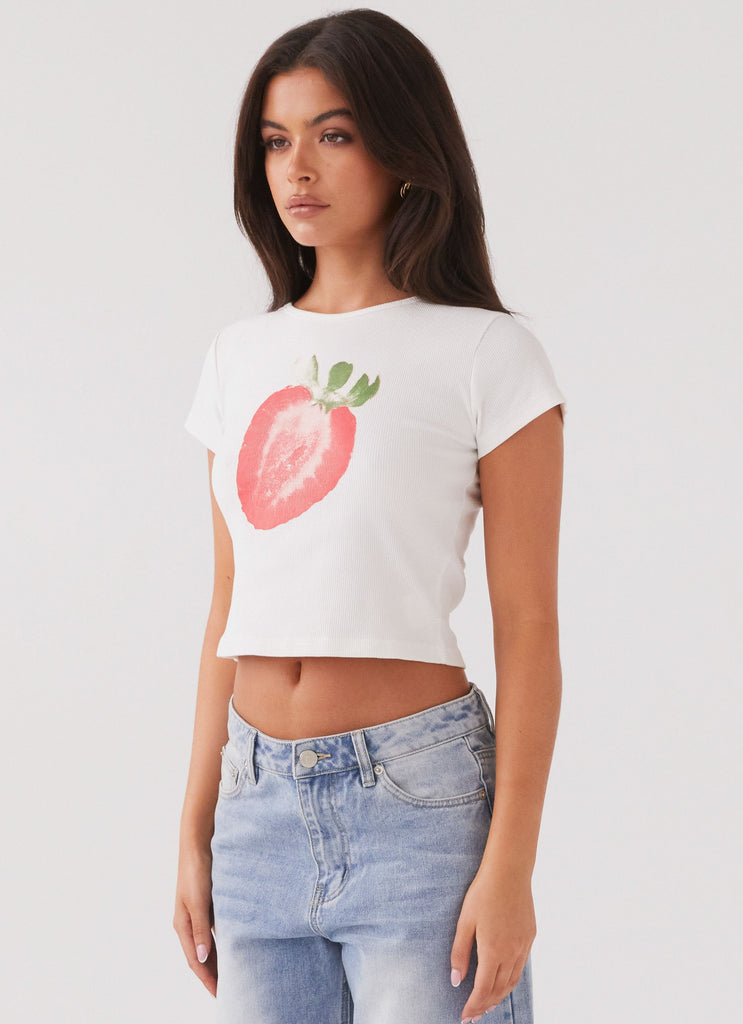 Womens Strawberry Shortcake Graphic Baby Tee in the colour White in front of a light grey background