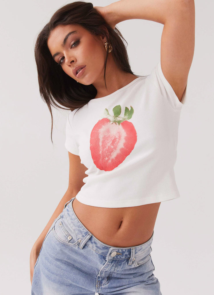 Womens Strawberry Shortcake Graphic Baby Tee in the colour White in front of a light grey background