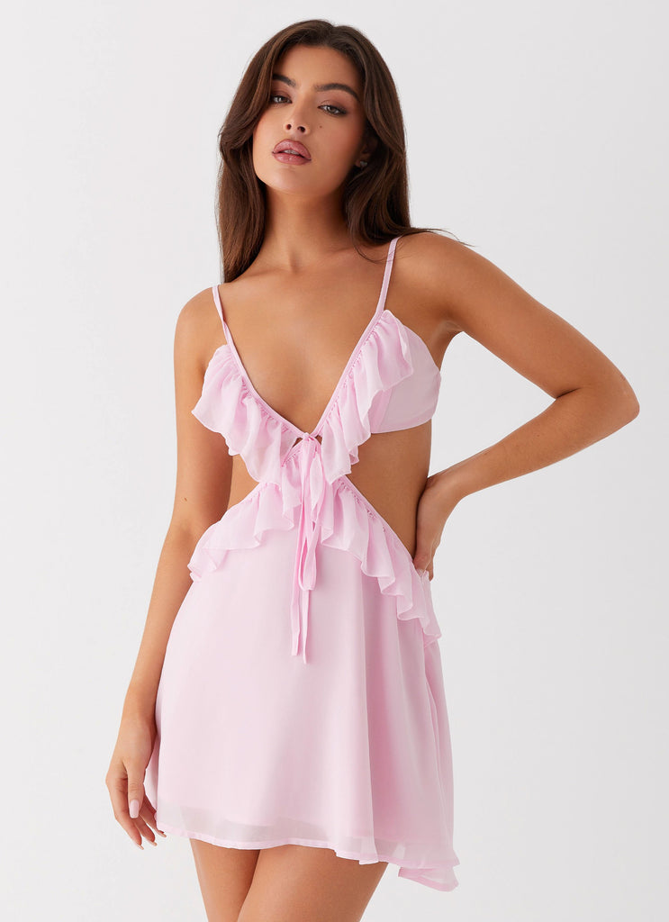 Womens Polly Ruffle Mini Dress in the colour Pink in front of a light grey background