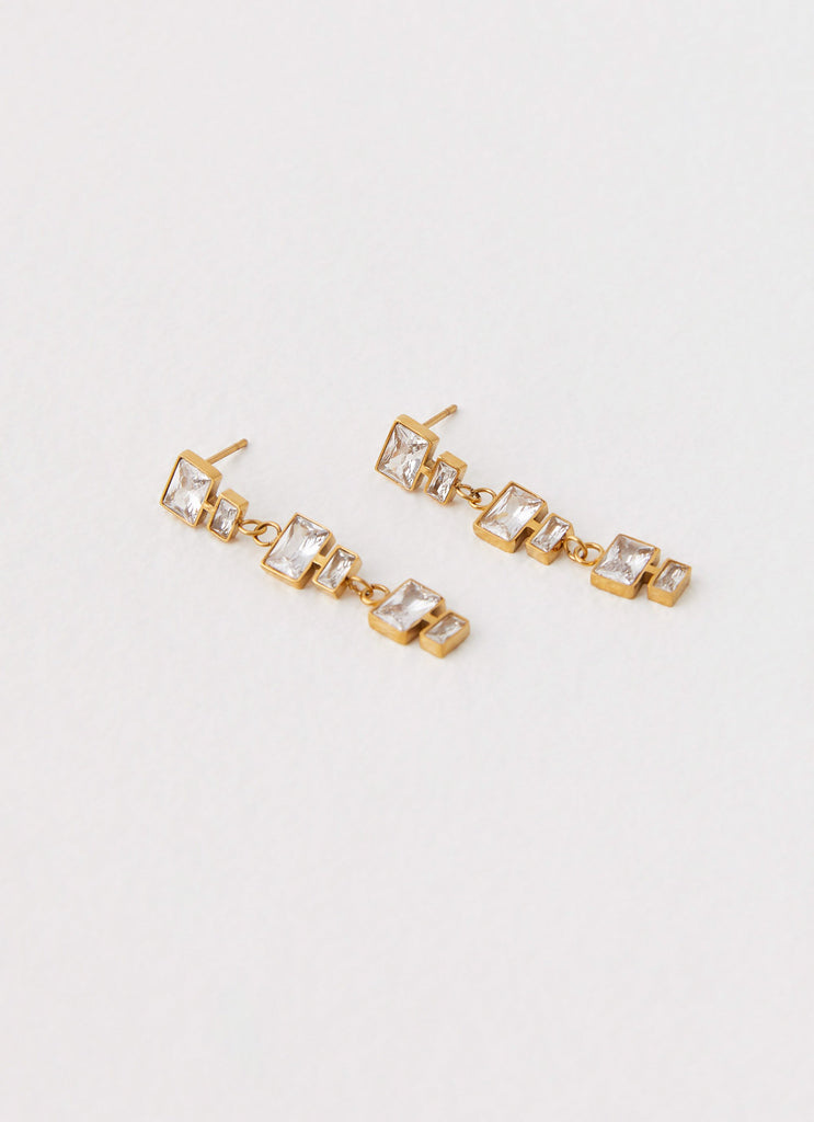 Womens Speed Of Light Earrings in the colour Gold in front of a light grey background